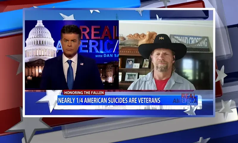 Video still from Real America on One America News Network showing a split screen of the host on the left side, and on the right side is the guest, Michael Carmichael.