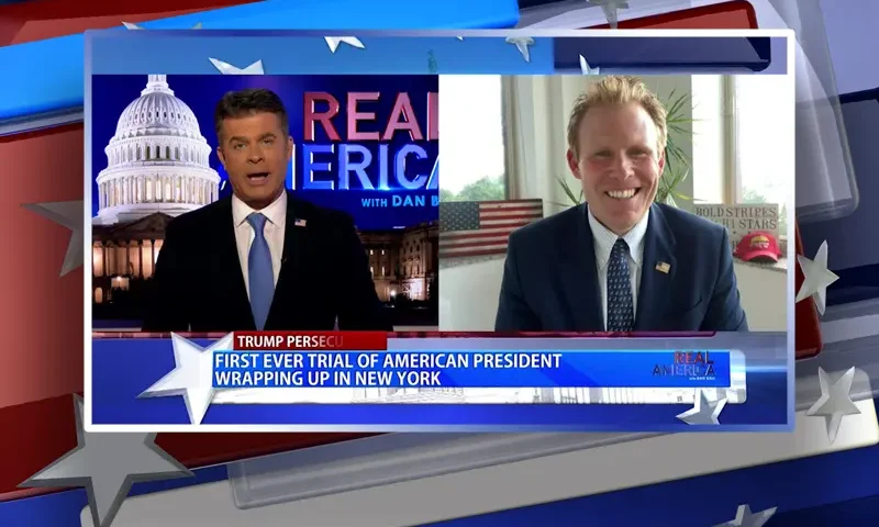 Video still from Real America on One America News Network showing a split screen of the host on the left side, and on the right side is the guest, Andrew Giuliani.