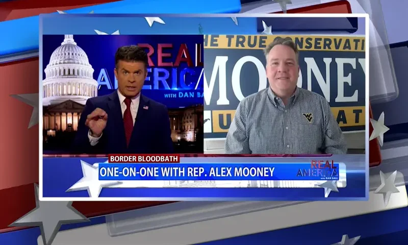 Video still from Real America on One America News Network showing a split screen of the host on the left side, and on the right side is the guest, Rep. Alex Mooney.