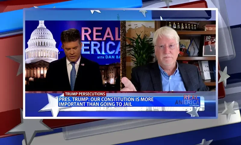 Video still from Real America on One America News Network showing a split screen of the host on the left side, and on the right side is the guest, Joe Hoft.
