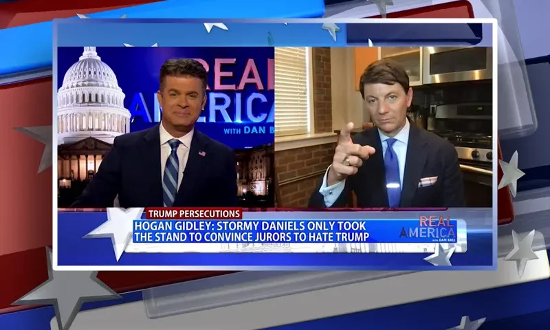 Video still from Real America on One America News Network showing a split screen of the host on the left side, and on the right side is the guest, Hogan Gidley.