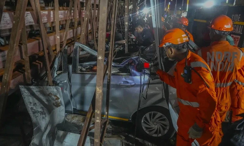 Rescuers look for victims under a billboard that collapsed following heavy rain and thundershowers in Mumbai, India, Monday, May 13, 2024. Scores of people were thought to be trapped after the collapse in the suburb of Ghatkopar, Mumbai police said on social media platform X. (AP Photo/Rafiq Maqbool)