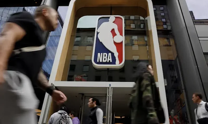 The NBA logo is displayed as people pass by the NBA Store in New York City, U.S., October 7, 2019. REUTERS/Brendan McDermid/File Photo