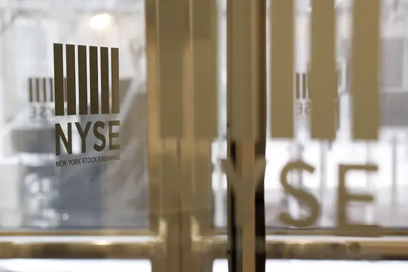 The logo of the New York Stock Exchange (NYSE) is seen on the door in New York, U.S., March 18, 2020. REUTERS/Lucas Jackson