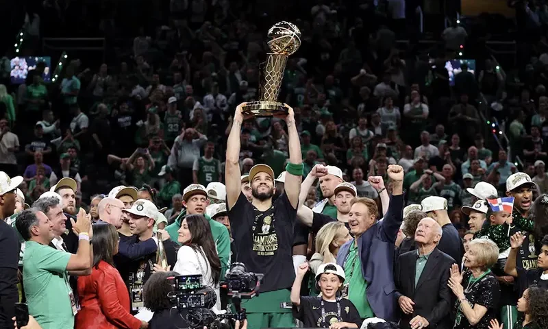 Boston Celtics forward Jayson Tatum (0) lifts the trophy after winning the 2024 NBA Finals against the Dallas Mavericks at TD Garden. Mandatory Credit: Peter Casey-USA TODAY Sports
