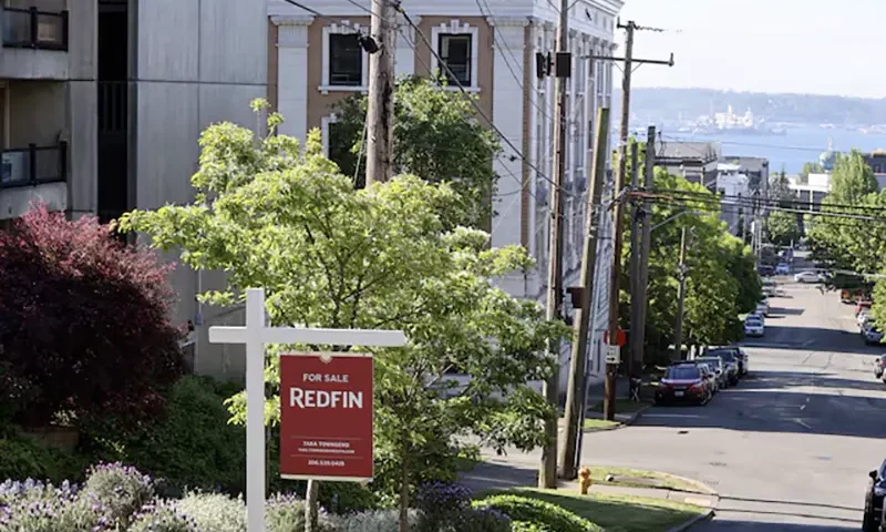 A "For Sale" sign is posted outside a residential home in the Queen Anne neighborhood of Seattle, Washington, U.S. May 14, 2021. REUTERS/Karen Ducey/File Photo