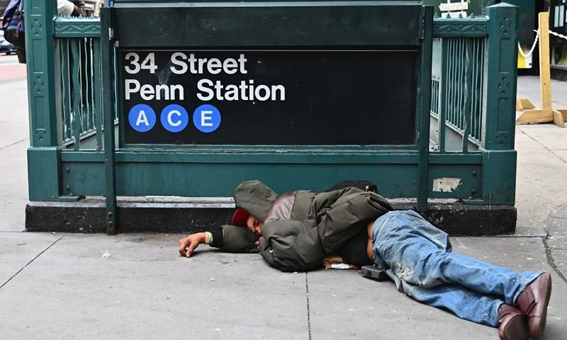 A man sleeps near Penn Station by Madison Square Gardens on September 17, 2020 in New York City. (Photo by Angela Weiss / AFP) (Photo by ANGELA WEISS/AFP via Getty Images)