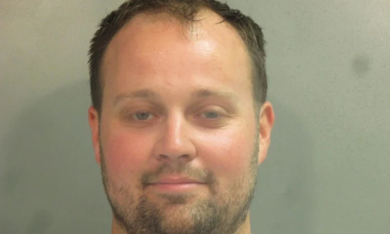 FAYETTEVILLE, AR - APRIL 29: In this handout photo provided by the Washington County Sheriff’s Office, former television personality on "19 Kids And Counting" Josh Duggar poses for a booking photo after his arrest April 29, 2021 in Fayetteville, Arkansas. Duggar was reportedly arrested by federal agents and is being detained on a federal hold. (Photo by Washington County Sheriff’s Office via Getty Images)