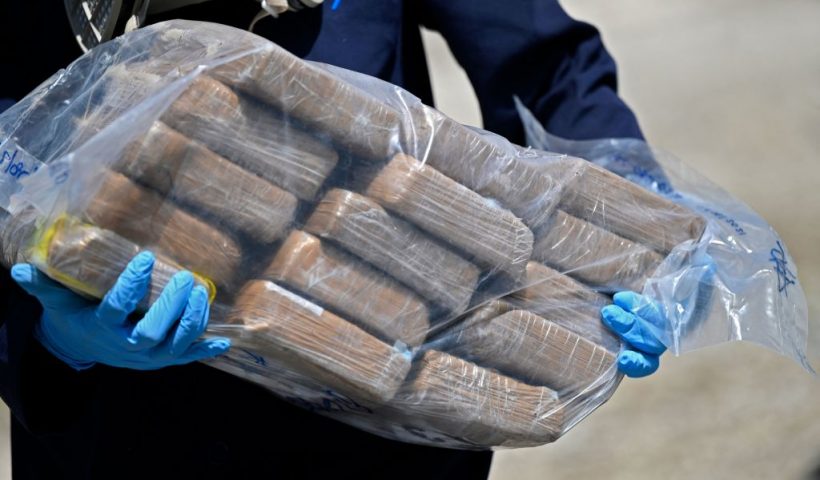 A member of the Attorney General's office carries a bag with packages of cocaine to be incinerated in Ilopango, El Salvador, on August 10, 2021. - 1,370 kilos of drug were seized from six foreigners 490 nautical miles south of Punta Remedios in Acajutla, Sonsonate, on July 31, 2021. (Photo by MARVIN RECINOS / AFP) (Photo by MARVIN RECINOS/AFP via Getty Images)