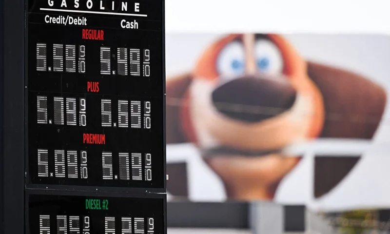 Gasoline fuel prices are displayed above a gas station near a billboard in Los Angeles, California, on July 19, 2022 . US gasoline prices have fallen from historic highs earlier in the summer, a retreat highlighted by a politically beset White House as a sign of moderating inflation. President Joe Biden took to Twitter to point out that prices at the pump have fallen for more than a month, saving the average driver about $25 a month. Gasoline prices are now at a national average of $4.495 per gallon, down 10 percent from a month ago but up 42 percent from the year-ago level, according to the American Automobile Association. (Photo by Patrick T. FALLON / AFP) (Photo by PATRICK T. FALLON/AFP via Getty Images)