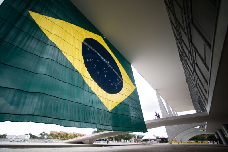 BRASILIA, BRAZIL - OCTOBER 31: Guards stand next to a Brazilian flag at the Planalto Palace entrance the day after Lula da Silva defeated incumbent Jair Bolsonaro in the presidential runoff on October 31, 2022 in Brasilia, Brazil. President of Brazil Jair Bolsonaro had not officially conceded defeat by Monday morning. (Photo by Andressa Anholete/Getty Images)