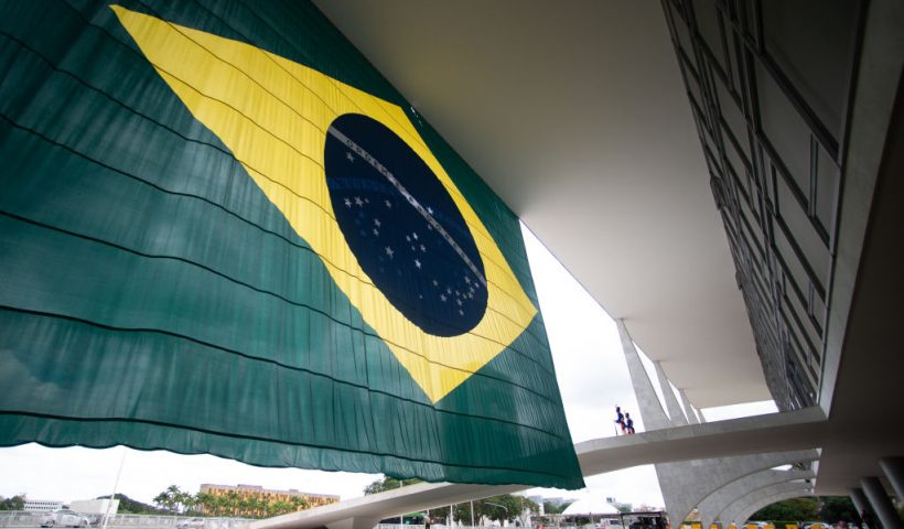 BRASILIA, BRAZIL - OCTOBER 31: Guards stand next to a Brazilian flag at the Planalto Palace entrance the day after Lula da Silva defeated incumbent Jair Bolsonaro in the presidential runoff on October 31, 2022 in Brasilia, Brazil. President of Brazil Jair Bolsonaro had not officially conceded defeat by Monday morning. (Photo by Andressa Anholete/Getty Images)