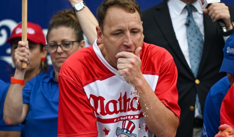 NEW YORK, NEW YORK - JULY 04: Defending champion Joey Chestnut competes in the 2023 Nathan's Famous Fourth of July International Hot Dog Eating Contest on July 4, 2023 at Coney Island in the Brooklyn borough of New York City. The men's contest was postponed due to thunderstorms but later happened without spectators allowed into the "arena." The annual contest, which began in 1972, draws thousands of spectators to Nathan’s Famous located on Surf Avenue. (Photo by Alexi J. Rosenfeld/Getty Images)