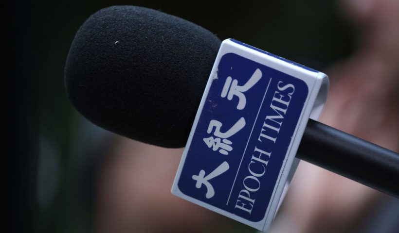 BERLIN GERMANY - OCTOBER 23: A reporter for The Epoch Times holds a microphone during a media event on October 23, 2023 in Berlin, Germany. The Epoch Times is owned by Epoch Media Group and is affiliated with the Falun Gong movement. (Photo by Sean Gallup/Getty Images)
