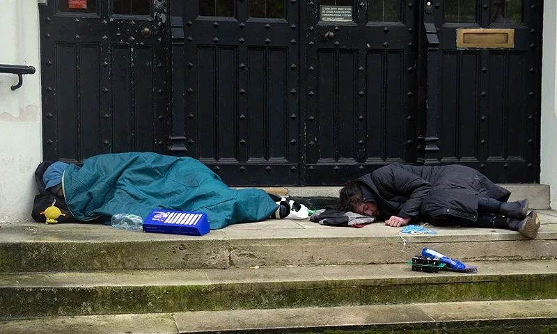 LONDON, ENGLAND - MAY 6: Homeless people sleep on a doorstep on May 6, 2024 in London, England. The early May Day bank holiday was inaugurated in the UK in 1978 but dates back to 1890 when it became associated with International Workers' Day and labour protests. (Photo by Carl Court/Getty Images)