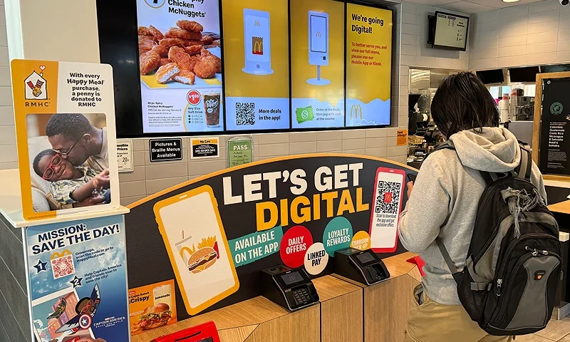 SAN FRANCISCO, CALIFORNIA - MAY 08: A sign advertising a digital ordering app is displayed at a McDonald's restaurant on May 08, 2024 in San Francisco, California. One month after California raised the minimum wage for fast food workers to $20 per hour, menu prices at some chain fast food restaurants have surged as much as 8 percent. (Photo by Justin Sullivan/Getty Images)