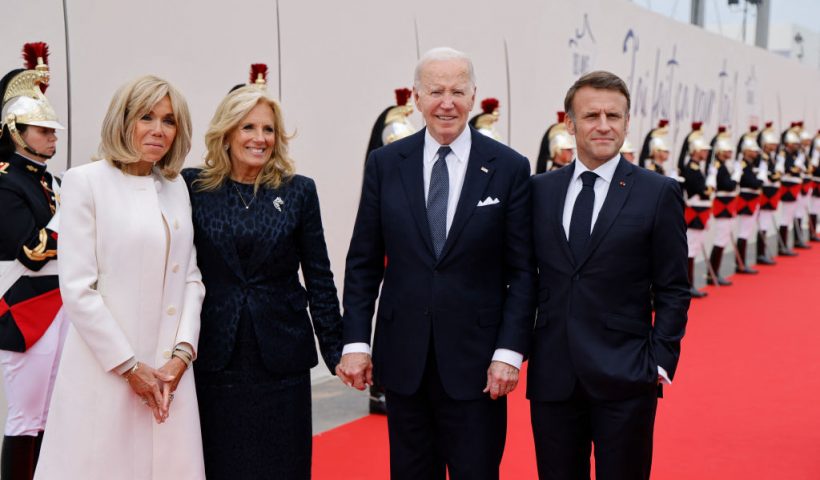 France's President Emmanuel Macron (R), French President's wife Brigitte Macron (L) pose with US President Joe Biden and US First Lady Jill Biden upon their arrival to attend the International commemorative ceremony at Omaha Beach marking the 80th anniversary of the World War II "D-Day" Allied landings in Normandy, in Saint-Laurent-sur-Mer, in northwestern France, on June 6, 2024. The D-Day ceremonies on June 6 this year mark the 80th anniversary since the launch of 'Operation Overlord', a vast military operation by Allied forces in Normandy, which turned the tide of World War II, eventually leading to the liberation of occupied France and the end of the war against Nazi Germany. (Photo by Ludovic MARIN / AFP) (Photo by LUDOVIC MARIN/AFP via Getty Images)