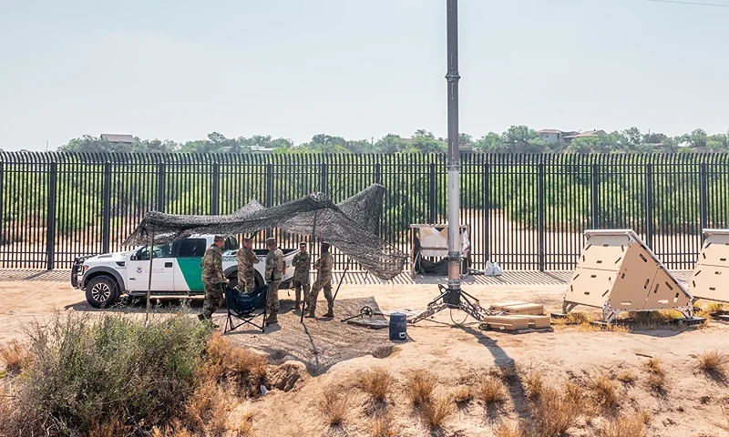 EAGLE PASS, TEXAS - JUNE 04: In an aerial view, National Guard members stand under shade while on patrol near the banks of the Rio Grande river on June 04, 2024 in Eagle Pass, Texas. President Biden is expected to sign an executive order that would prohibit migrants who illegally cross the southern border from claiming asylum in the U.S. The move comes after the collapse of a bipartisan Senate agreement on securing the border. (Photo by Brandon Bell/Getty Images)