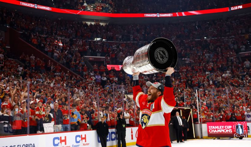 SUNRISE, FLORIDA - JUNE 24: Matthew Tkachuk #19 of the Florida Panthers lifts the Stanley Cup after Florida's 2-1 victory against the Edmonton Oilers in Game Seven of the 2024 Stanley Cup Final at Amerant Bank Arena on June 24, 2024 in Sunrise, Florida. (Photo by Bruce Bennett/Getty Images)