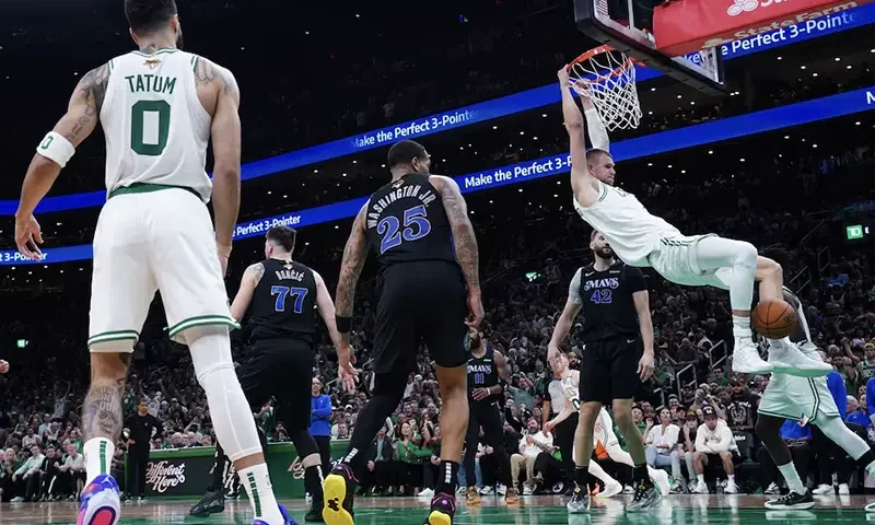 Boston Celtics center Kristaps Porzingis (8) dunks against the Dallas Mavericks in the third quarter during game one of the 2024 NBA Finals at TD Garden. Mandatory Credit: David Butler II-USA TODAY Sports