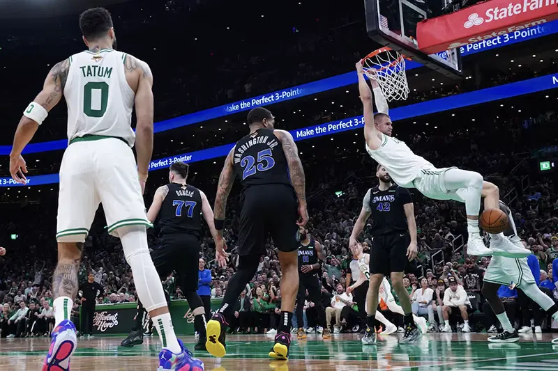 Boston Celtics center Kristaps Porzingis (8) dunks against the Dallas Mavericks in the third quarter during game one of the 2024 NBA Finals at TD Garden. Mandatory Credit: David Butler II-USA TODAY Sports