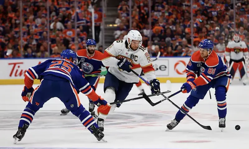 Florida Panthers center Aleksander Barkov (16) skates with the puck defended by Edmonton Oilers defenseman Darnell Nurse (25) and defenseman Philip Broberg (86) in the first period in game three of the 2024 Stanley Cup Final at Rogers Place. Mandatory Credit: Perry Nelson-USA TODAY Sports