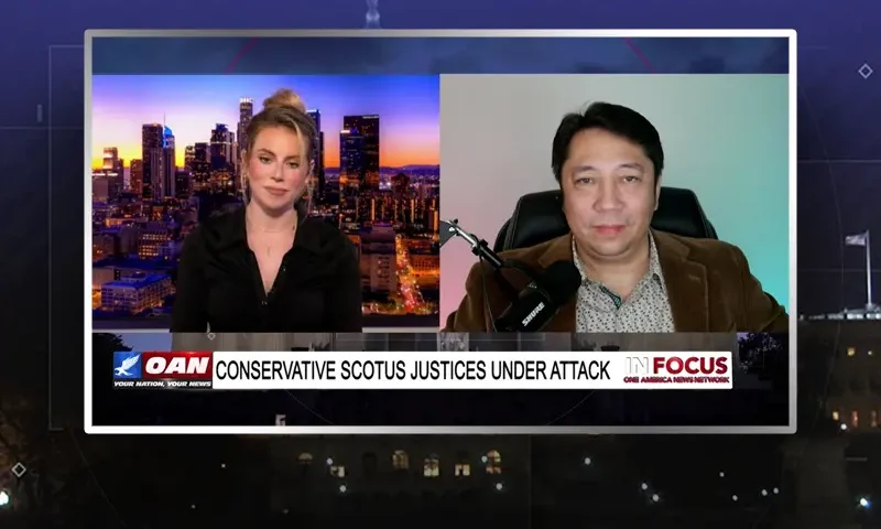 Video still from In Focus on One America News Network showing a split screen of the host on the left side, and on the right side is the guest, JD Rucker.