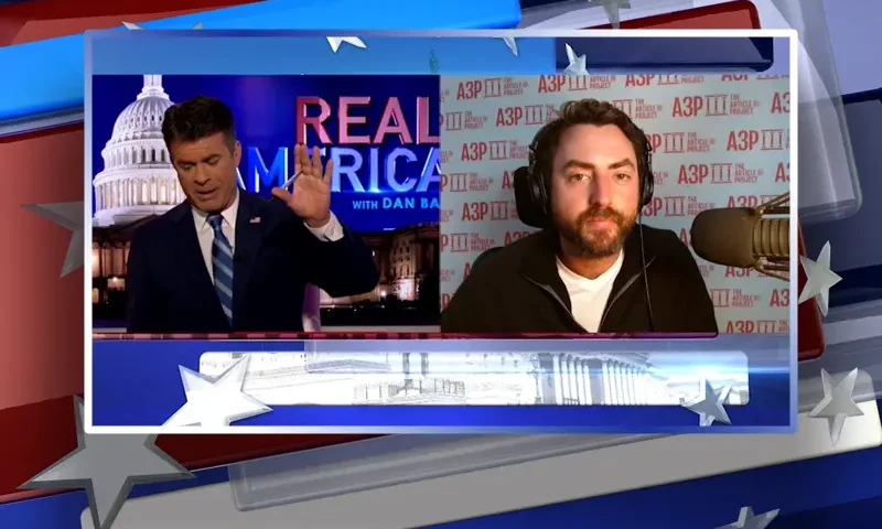 Video still from Real America on One America News Network showing a split screen of the host on the left side, and on the right side is the guest, Josh Hammer.
