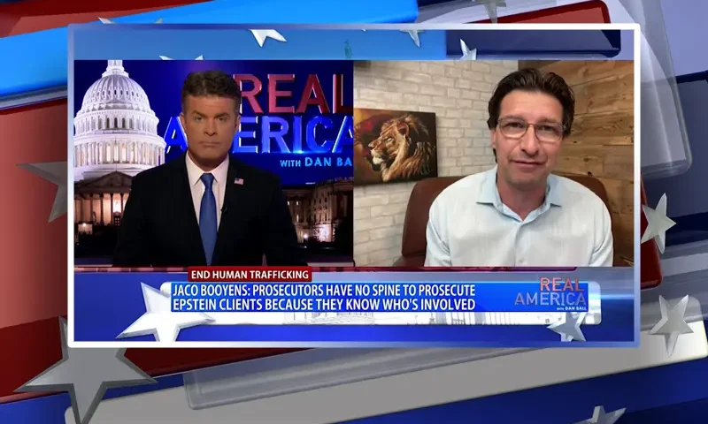 Video still from Real America on One America News Network showing a split screen of the host on the left side, and on the right side is the guest, Jaco Booyens.