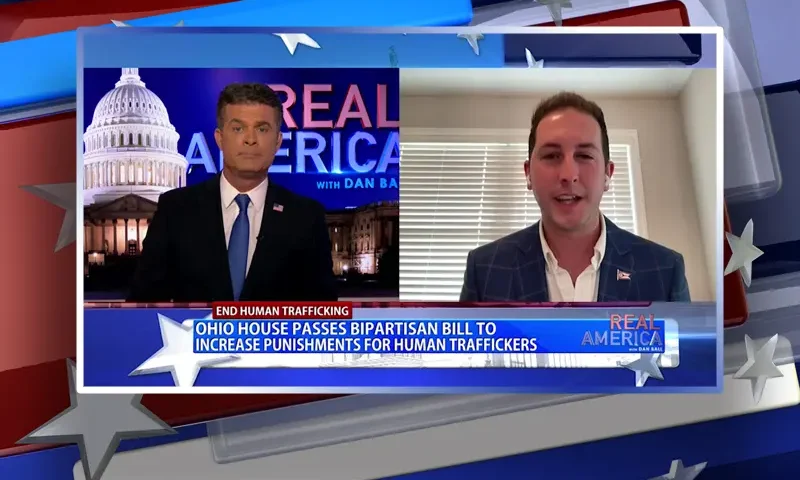 Video still from Real America on One America News Network showing a split screen of the host on the left side, and on the right side is the guest, Rep. Nick Santucci.