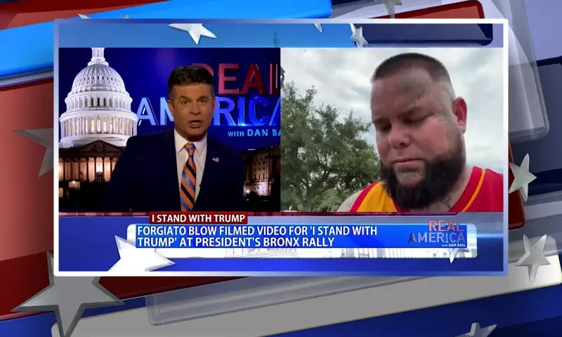 Video still from Real America on One America News Network showing a split screen of the host on the left side, and on the right side is the guest, Forgiato Blow.