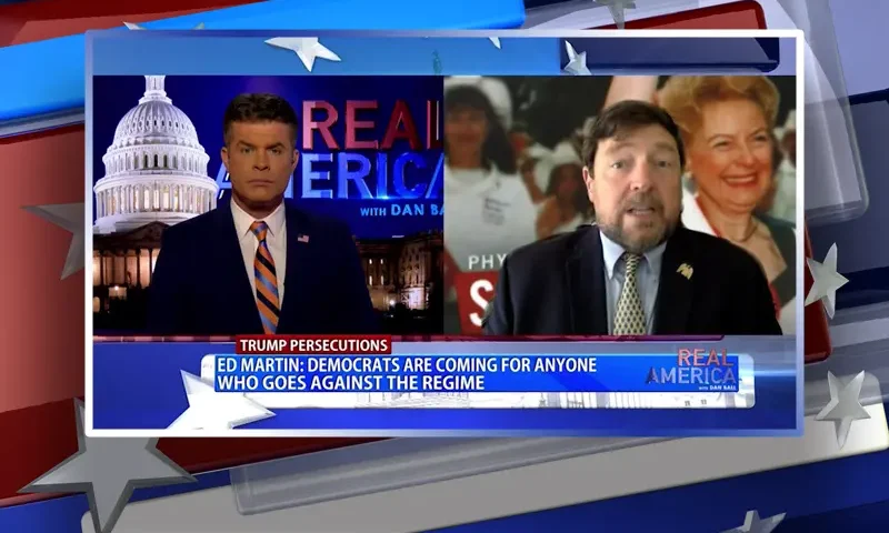Video still from Real America on One America News Network showing a split screen of the host on the left side, and on the right side is the guest, Ed Martin.