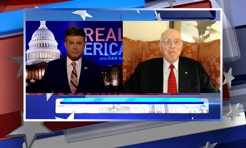 Video still from Real America on One America News Network showing a split screen of the host on the left side, and on the right side is the guest, Lt. Col. Robert Maginnis.