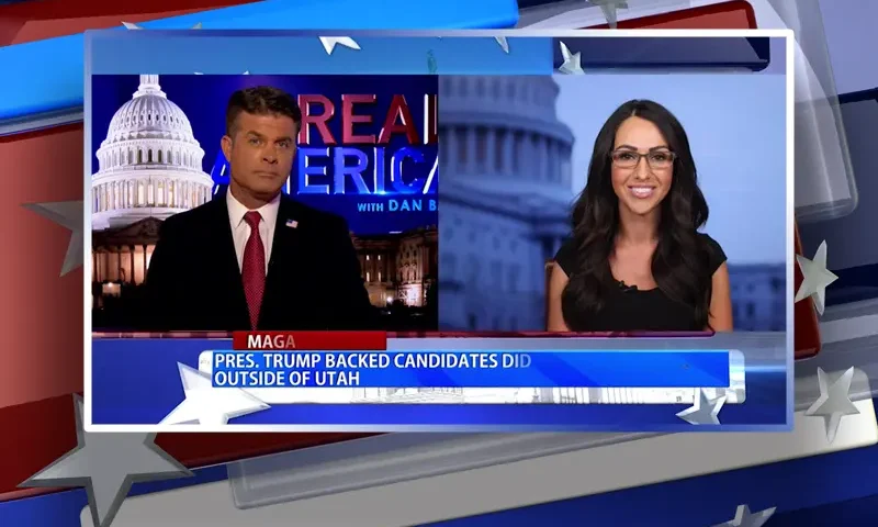 Video still from Real America on One America News Network showing a split screen of the host on the left side, and on the right side is the guest, Rep. Lauren Boebert.