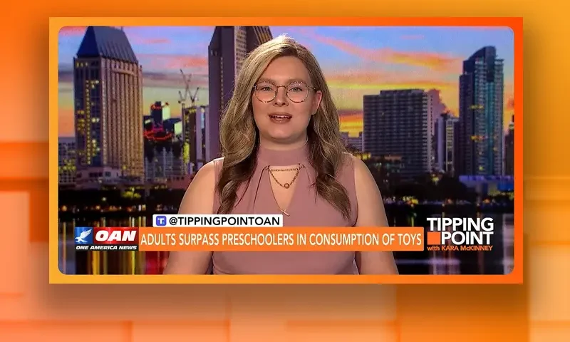 Video still of the host of Tipping Point at the desk of their talk show on One America News Network.