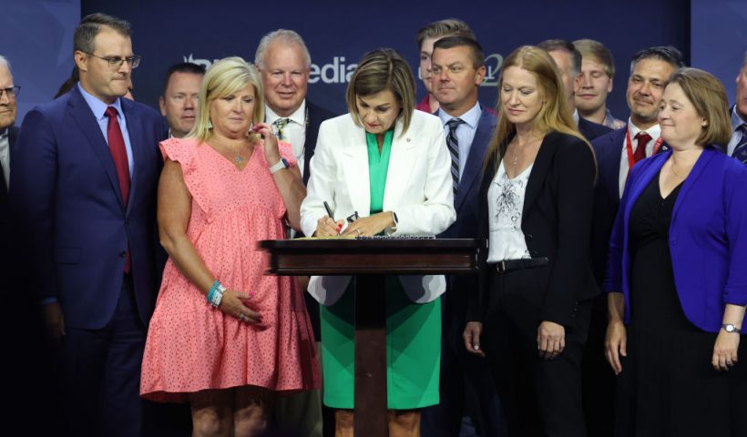 DES MOINES, IOWA - JULY 14: Iowa Governor Kim Reynolds signs into law a bill that will ban most abortions after around six weeks of pregnancy during a visit to the Family Leadership Summit on July 14, 2023 in Des Moines, Iowa. Several Republican presidential candidates were scheduled to speak at the event, billed as “The Midwest’s largest gathering of Christians seeking cultural transformation in the family, Church, government, and more.” (Photo by Scott Olson/Getty Images)