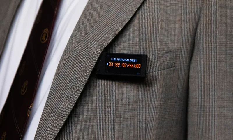 WASHINGTON, DC - APRIL 18: Rep. Thomas Massie (R-KY) wears a pin displaying the a live tally of the national debt during a House Committee on Rules business meeting at the U.S. Capitol on April 18, 2024 in Washington, DC. Speaker Mike Johnson (R-LA) is pushing aid to Ukraine, Israel and Taiwan through the House over the objections of the right-flank of his own party. (Photo by Kent Nishimura/Getty Images)