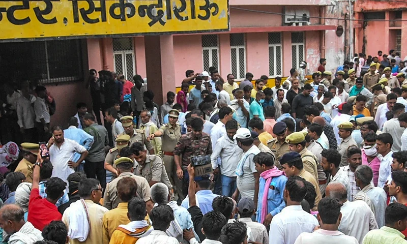 HATHRAS, INDIA - JULY 02: Relatives of victims who died in a stampede gather outside a hospital on July 02, 2024 in Hathras, India. At least 116 people were confirmed killed in a devastating stampede at a Satsang, or religious event, in Hathras, in India's densely populated Uttar Pradesh state on Tuesday. The stampede occurred as the event concluded and attendees were trying to exit, with the narrow exit leading to a deadly crush of the large crowd. Officials expected the death toll to continue climbing rapidly through the night. (Photo by Stringer/Getty Images)