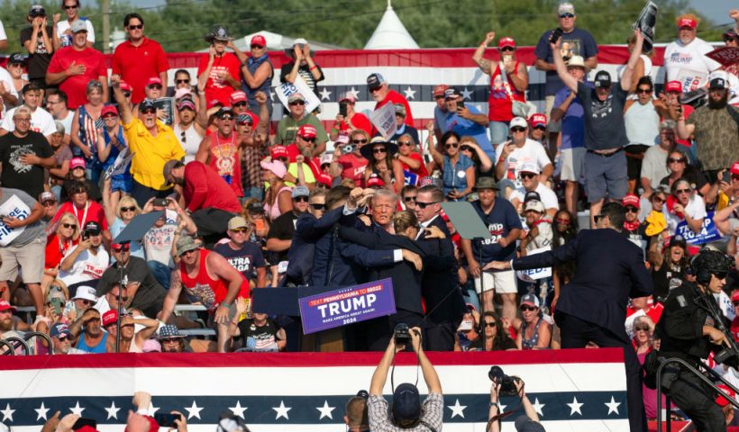 Republican candidate Donald Trump is seen with what appears to be blood on his face surrounded by secret service agents as he is taken off the stage at a campaign event at Butler Farm Show Inc. in Butler, Pennsylvania, July 13, 2024. Republican candidate Donald Trump was evacuated from the stage at today's rally after what sounded like shots rang out at the event in Pennsylvania, according to AFP.