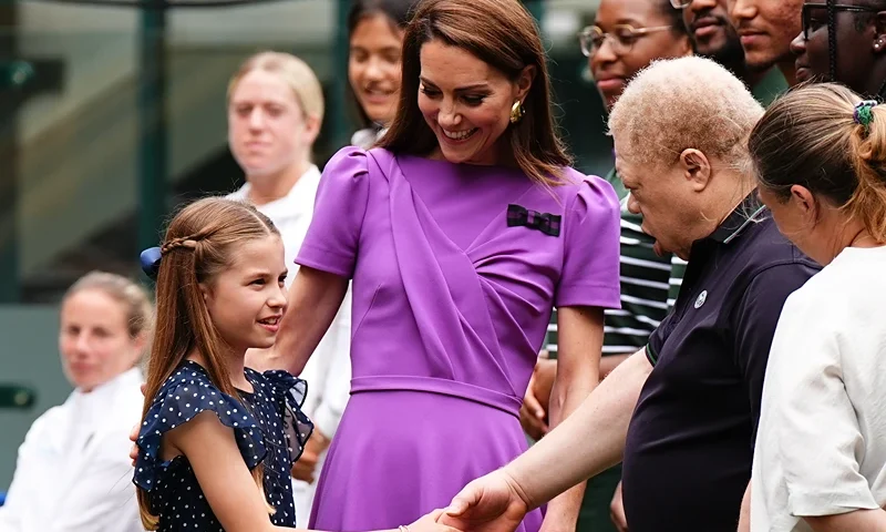 The Princess of Wales and Princess Charlotte Attend Wimbledon 2024 - Day 14 LONDON, ENGLAND - JULY 14: Catherine, Princess of Wales (2nd L) and Princess Charlotte (L) meet ground staff during a visit to the All England Lawn Tennis and Croquet Club in Wimbledon, south west London, on day fourteen of the Wimbledon Tennis Championships on July 14, 2024 in London, England. The Princess of Wales will present the trophy to the winner of the men's final. (Photo by Aaron Chown - WPA Pool/Getty Images)