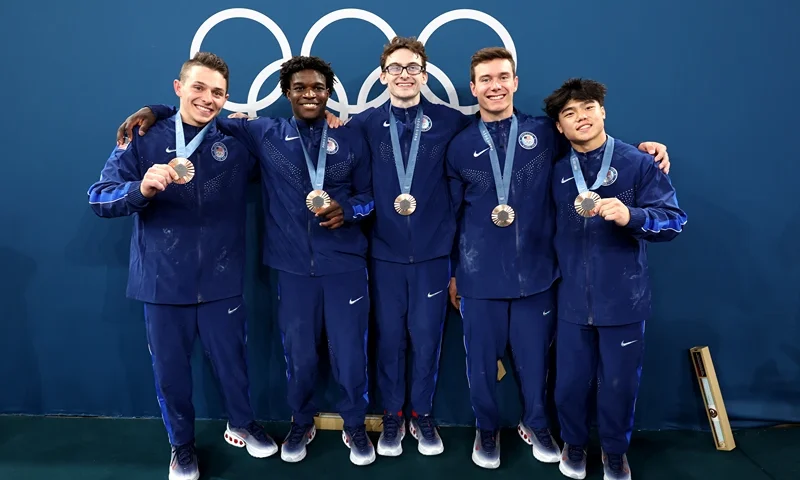 Artistic Gymnastics - Olympic Games Paris 2024: Day 3 PARIS, FRANCE - JULY 29: (L-R) Bronze medalists Paul Juda, Frederick Richard, Stephen Nedoroscik, Brody Malone and Asher Hong of Team United States pose with their medals during the medal ceremony for the Artistic Gymnastics Men's Team Final on day three of the Olympic Games Paris 2024 at Bercy Arena on July 29, 2024 in Paris, France. (Photo by Jamie Squire/Getty Images)