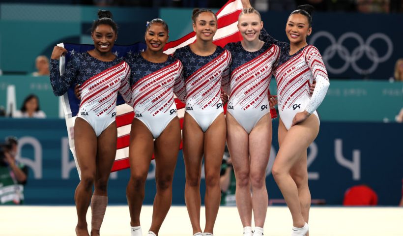 PARIS, FRANCE - JULY 30: (L-R) Simone Biles, Jordan Chiles, Hezly Rivera, Jade Carey and Sunisa Lee of Team United States celebrate after winning the gold medals during the Artistic Gymnastics Women's Team Final on day four of the Olympic Games Paris 2024 at Bercy Arena on July 30, 2024 in Paris, France. (Photo by Jamie Squire/Getty Images)