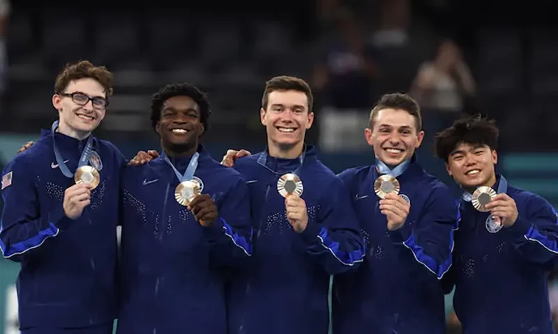 Bronze medallist's Stephen Nedoroscik, Paul Juda, Brody Malone, Frederick Richard and Asher Hong of United States celebrate on the podium with their medals. REUTERS/Hannah Mckay