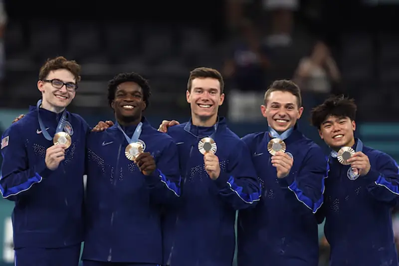 Bronze medallist's Stephen Nedoroscik, Paul Juda, Brody Malone, Frederick Richard and Asher Hong of United States celebrate on the podium with their medals. REUTERS/Hannah Mckay