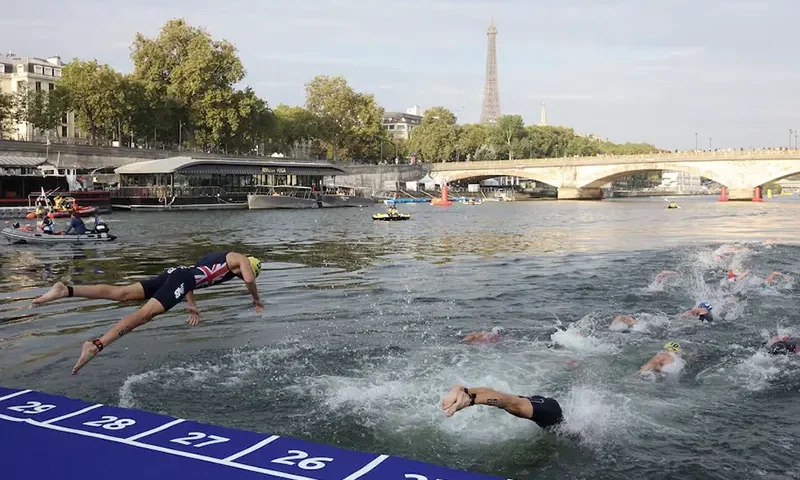 Athletes compete in the elite men triathlon test event in the river seine REUTERS/Stephanie Lecocq/File Photo