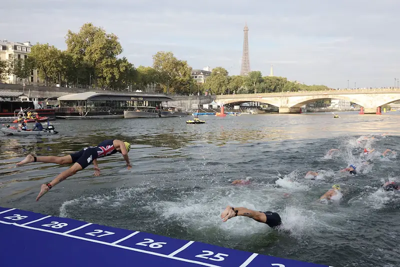 Athletes compete in the elite men triathlon test event in the river seine REUTERS/Stephanie Lecocq/File Photo