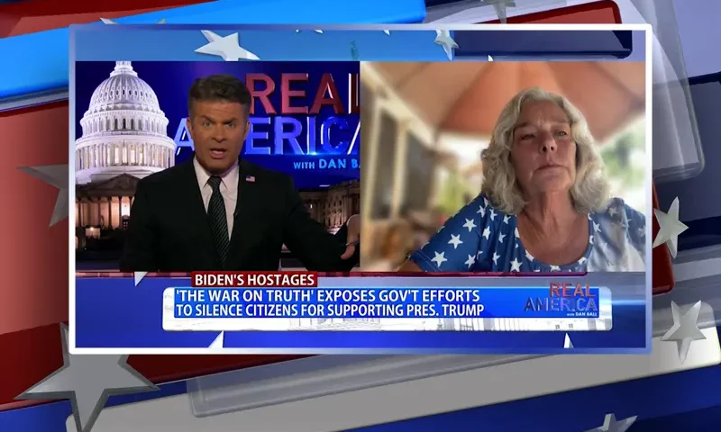 Video still from Real America on One America News Network showing a split screen of the host on the left side, and on the right side is the guest, Micki Witthoeft.