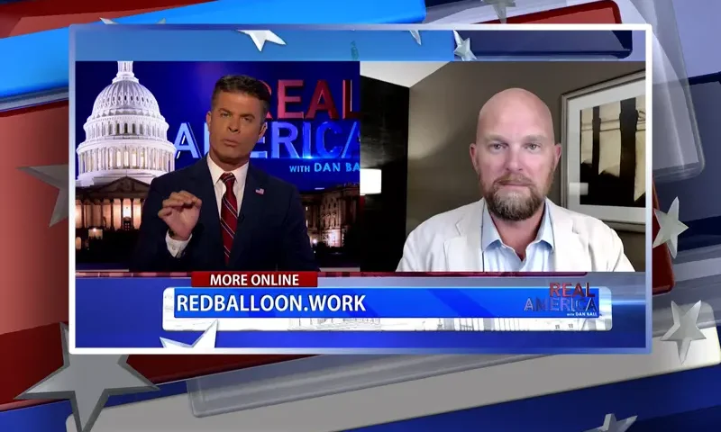 Video still from Real America on One America News Network showing a split screen of the host on the left side, and on the right side is the guest, Andrew Crapuchetts.