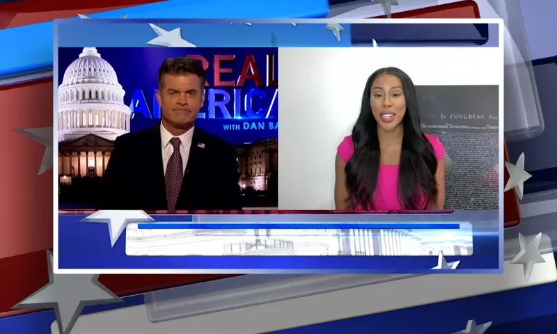 Video still from Real America on One America News Network showing a split screen of the host on the left side, and on the right side is the guest, Kimberly Klacik.