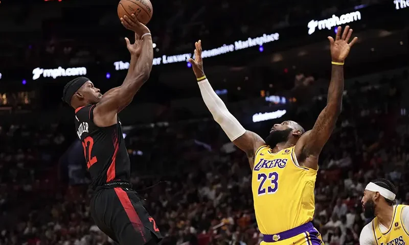 Miami Heat forward Jimmy Butler (22) shoots over Los Angeles Lakers forward LeBron James (23) during the first half at Kaseya Center. Mandatory Credit: Jasen Vinlove-USA TODAY Sports/File photo